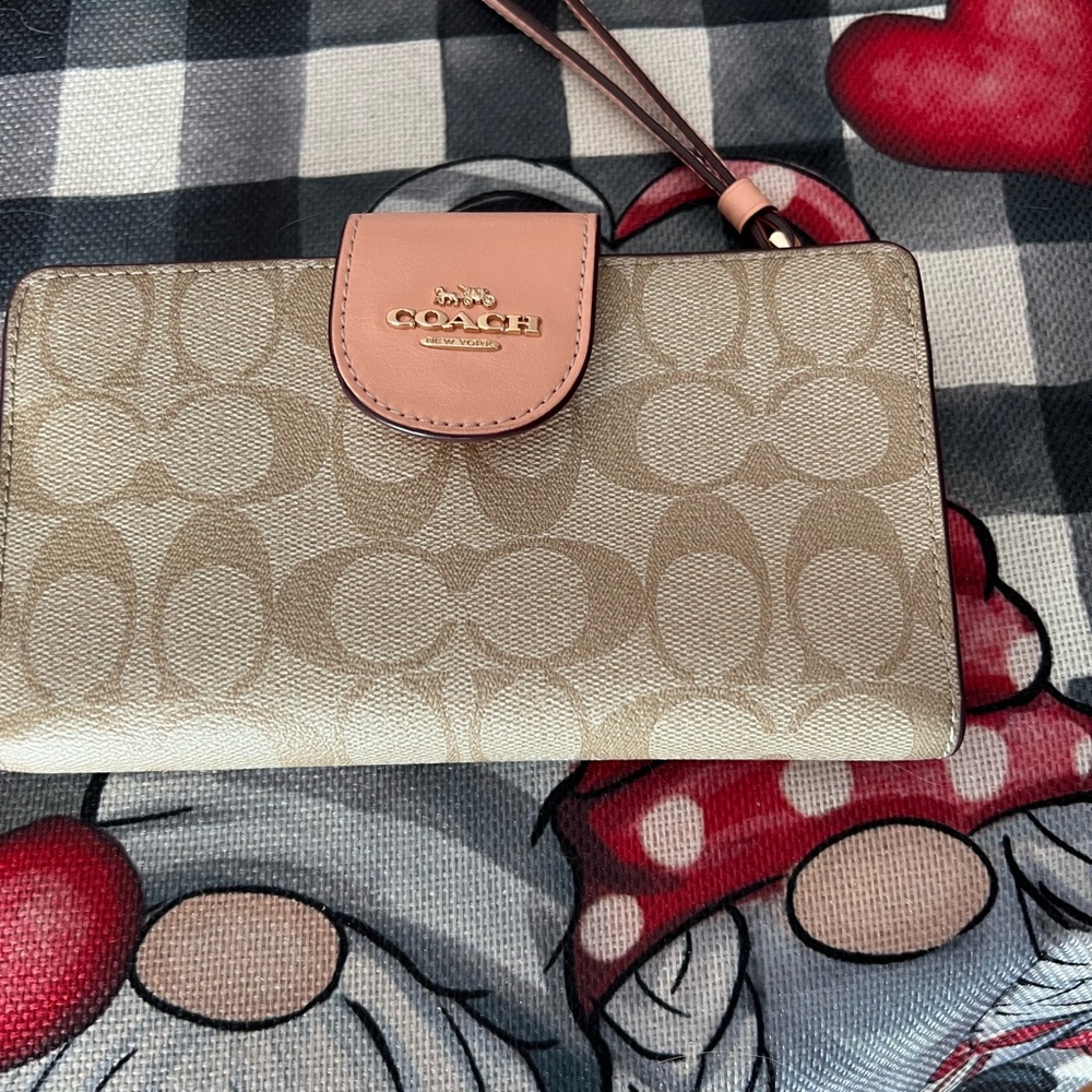 Coach Tech wallet on signature canvas.